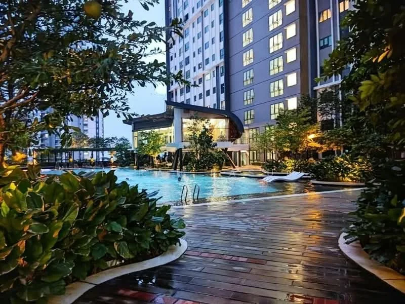 Exterior type: high-rise condominium; features: infinity pool, pool deck with loungers, landscaped garden with tropical plants, wooden decking, modern clubhouse, floor-to-ceiling windows on clubhouse, surrounded by greenery, night lighting, water features, swimming pool with steps; style: modern.