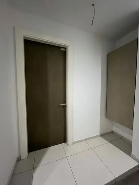 Room features: white painted walls, light grey floor tiles, wooden door, door handle, built-in wall panel, neutral color scheme; style: modern.