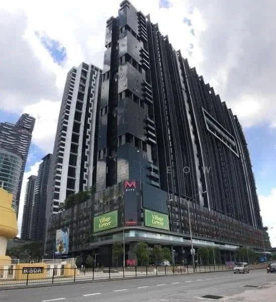 Exterior type: high-rise condominium; features: glass curtain wall, black painted facade, recessed balconies, projecting balconies, feature lighting at night, surrounded by mature greenery, commercial space at ground level, signage for Village Center, multiple storeys, urban context with surrounding buildings; style: modern.