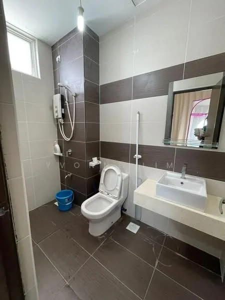 Bathroom features: white ceramic toilet, single-sink vanity with stone countertop, framed mirror, shower with wall-mounted showerhead, grey tiled walls, brown accent wall, light fixture, window for natural light, blue plastic bucket; style: modern.