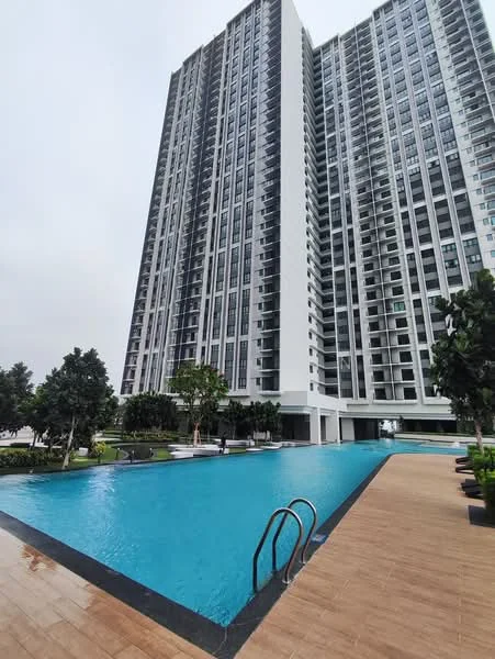 Exterior type: high-rise condominium; features: infinity pool, pool deck with loungers, landscaped garden, mature trees, glass curtain wall facade, balconies on upper floors, surrounded by greenery, modern architectural design; style: modern.