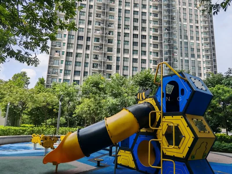 Exterior type: high-rise condominium; features: playground equipment with slide, manicured landscaping, mature trees, concrete pathway, water feature, multiple storeys, glass windows, balconies visible; style: modern.