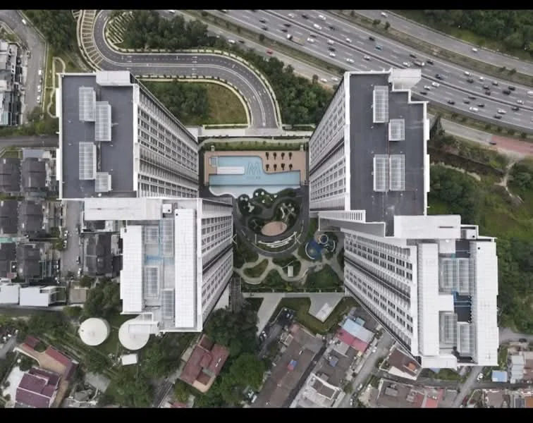 Exterior type: high-rise condominium; features: two interconnected towers, landscape garden in the center, infinity pool, swimming pool deck, children's playground, jogging track, manicured lawns, surrounding greenery, parking area visible, proximity to main road, urban context with nearby residential areas; style: modern.
