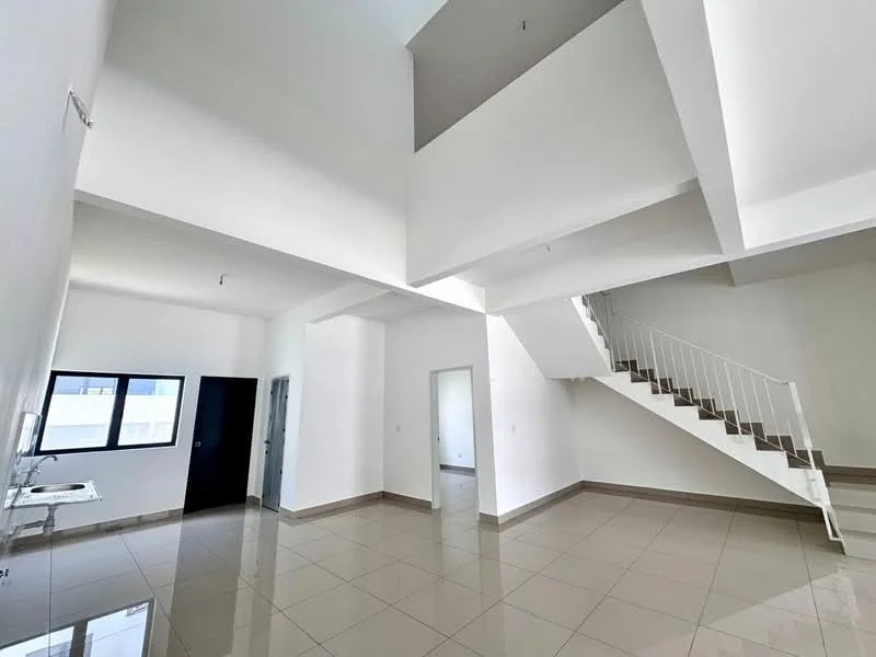 Room features: white painted walls, grey tiled flooring, staircase with white railing, large windows, high ceiling, open layout, kitchenette area with sink, natural light from windows; style: modern.