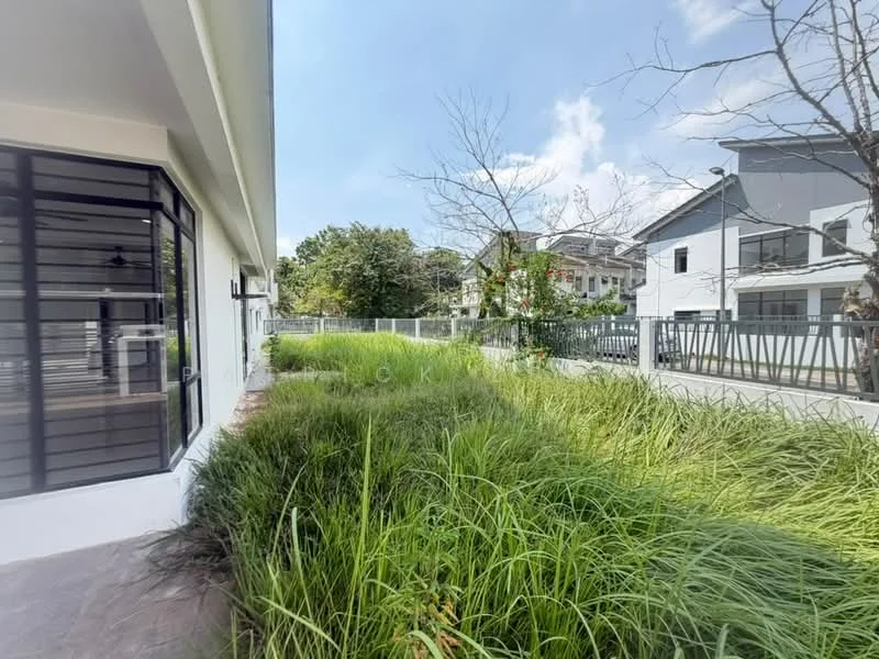 Exterior type: detached bungalow; features: manicured lawn, tall grass landscaping, paved walkway, fence surrounding property, large windows, modern facade, surrounded by greenery, clear blue sky; style: modern.