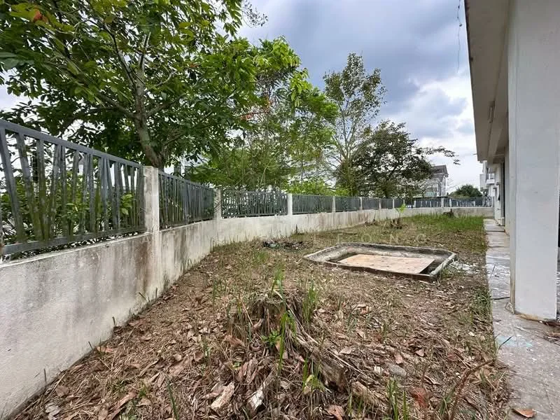 Exterior features: fenced perimeter, overgrown grass, dirt patch, concrete slab, surrounding trees, cloudy sky.
