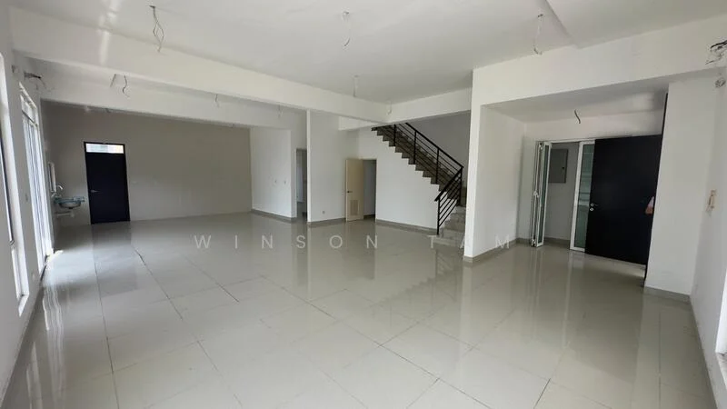 Room features: white painted walls, polished ceramic tile flooring, large windows providing natural light, staircase leading to upper floor, open layout, ceiling with exposed lighting fixtures, doorway leading to another room, corner area for potential kitchen or dining setup; style: modern.