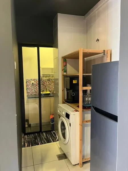 Laundry features: white front-load washing machine, stainless-steel fridge, wooden shelving unit, coffee machine, tile flooring, grey painted walls, glass sliding door, colorful tiled backsplash, kitchen area visible in background; style: modern.