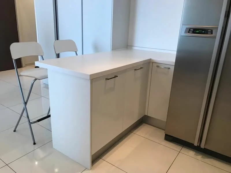 Kitchen features: white laminate countertop, white cabinetry with handle, stainless-steel fridge, white tiled flooring, folding metal chair, corner kitchen layout; style: modern.