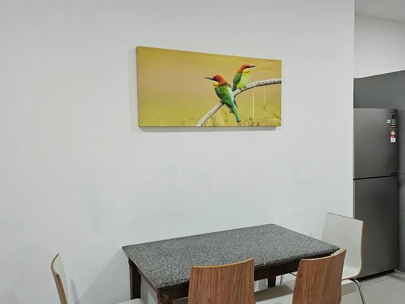 Dining features: granite dining table, 4 wooden dining chairs, framed artwork on wall, white painted walls, black fridge; style: modern.