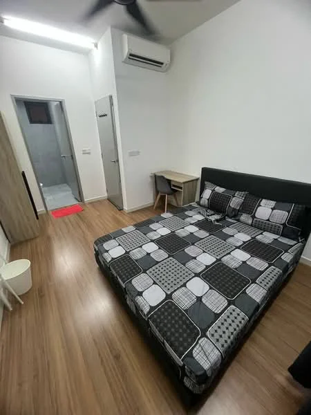 Bedroom features: king-size bed with patterned bedding, wooden flooring, 1 wall-mounted split AC, ceiling fan, study desk, chair, white walls, built-in wardrobe, door leading to bathroom, small waste bin; style: modern.