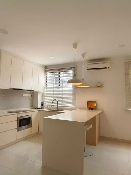 Kitchen features: white cabinetry, marble countertop, stainless-steel sink, chrome pull-down faucet, built-in oven, recessed downlights, pendant light, window with blinds, air conditioning unit, bar seating area; style: modern.