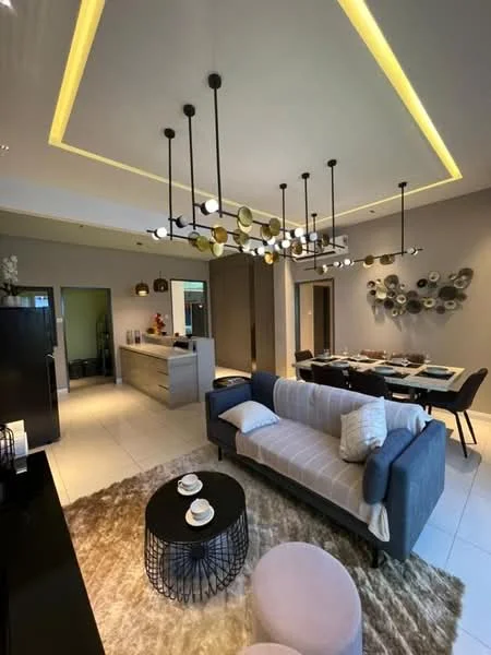 Living features: grey fabric sofa, round black coffee table, area rug with geometric pattern, pendant light fixture with multiple bulbs, recessed ceiling lights, wall-mounted decorative art, open layout to dining area, white walls, tile flooring; style: modern. Dining features: dining table for six, black dining chairs, decorative wall art, white walls, tile flooring; style: modern.