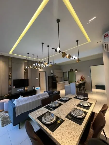 Dining features: dining table with granite top, upholstered dining chairs, decorative table setting with plates and cutlery, pendant lighting with multiple bulbs, recessed LED lighting in ceiling, open-plan layout, wall-mounted TV, grey sofa, kitchen area visible in background, white walls, light-colored flooring, air conditioning unit; style: modern. Kitchen features: kitchen cabinetry with grey finish, stainless-steel appliances, open shelving, countertop with bar seating, refrigerator, built-in oven, microwave, ceramic tile flooring; style: modern.