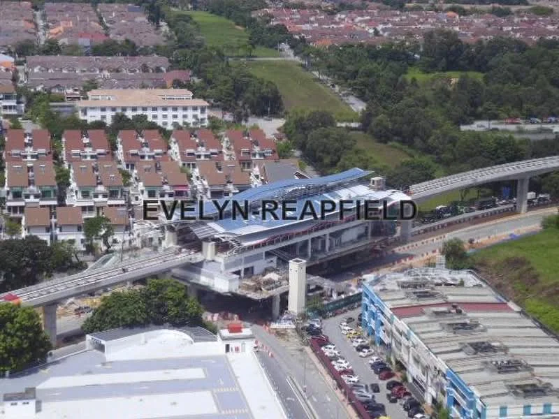 Exterior features: aerial view, surrounding residential area, train station with roof, roadway, parking area, green landscaping, multi-storey buildings in background, single-storey commercial buildings in foreground; style: modern.