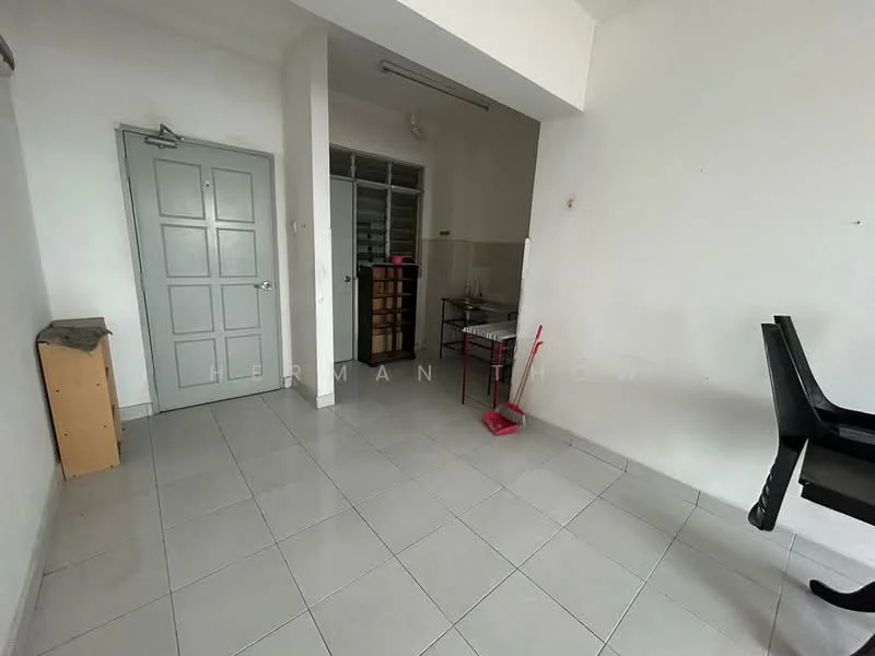 Room features: white painted walls, grey tiled flooring, single door, large window, wooden shelving unit, small table, plastic chair, broom, empty space; style: minimalist.