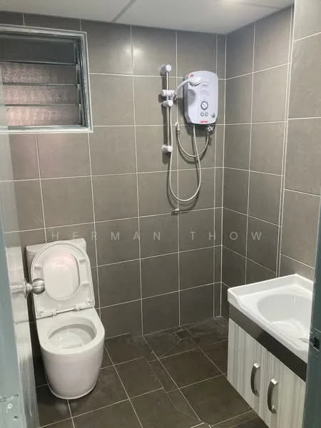 Bathroom features: grey ceramic tile walls, grey ceramic tile flooring, one-piece toilet, shower with handheld showerhead, water heater, vanity with sink, white cabinetry under sink, window for natural light; style: modern.