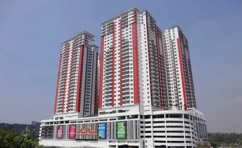 Exterior type: high-rise condominium; features: glass curtain wall, red and white painted facade, multiple storeys, balconies on each unit, commercial space at ground level, parking deck, surrounded by greenery; style: modern.