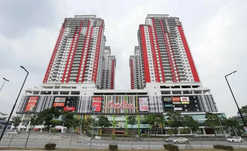 Exterior type: high-rise condominium; features: glass curtain wall, red and white painted facade, multiple storeys, retail space at ground level, surrounded by landscaping, balconies on upper floors, signage for various shops, modern architectural design; style: modern.