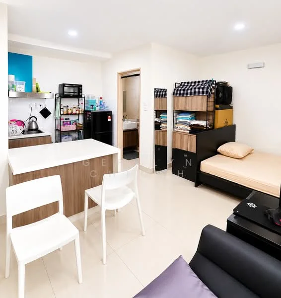 Living features: white painted walls, cream tiled flooring, recessed downlights, kitchenette with blue accent wall, stainless-steel sink, black refrigerator, microwave, wooden dining table with 3 white chairs, single bed with beige bedding, open shelving unit with stacked towels and linens, black sofa, wall-mounted air conditioning unit; style: modern.