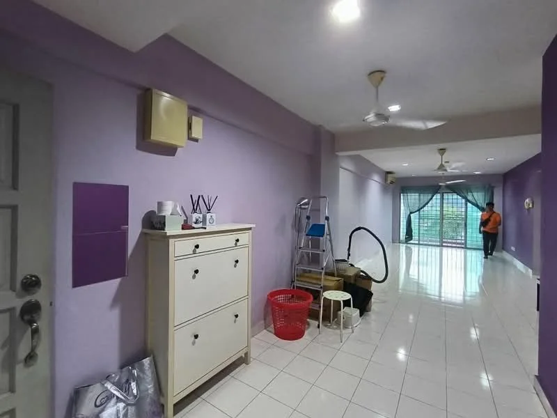 Room features: purple painted walls, white tiled flooring, 2 ceiling fans, large glass sliding door, curtains, white dresser with drawers, red plastic basket, step ladder, vacuum cleaner, wooden storage box, decorative wall clock, light fixtures in ceiling; style: modern; view: garden.