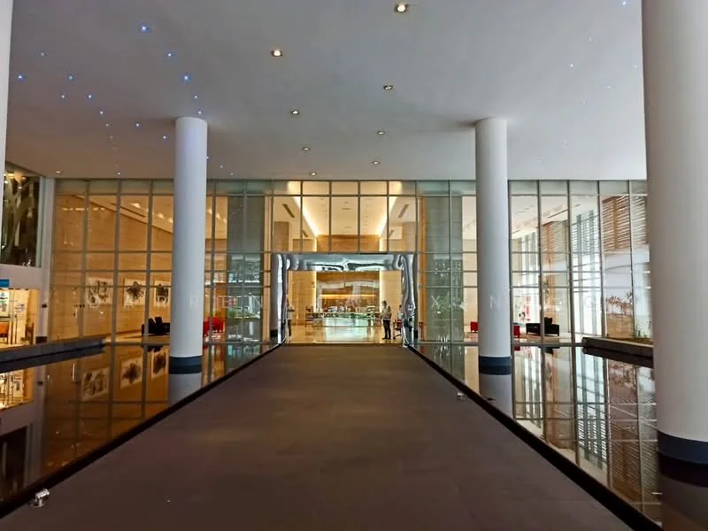 Exterior type: high-rise condominium; features: glass curtain wall, marble flooring at entrance, double-volume main lobby, recessed lighting, large glass doors, decorative wall art, water feature, potted plants, open space layout, high ceilings, modern architectural design; style: modern.