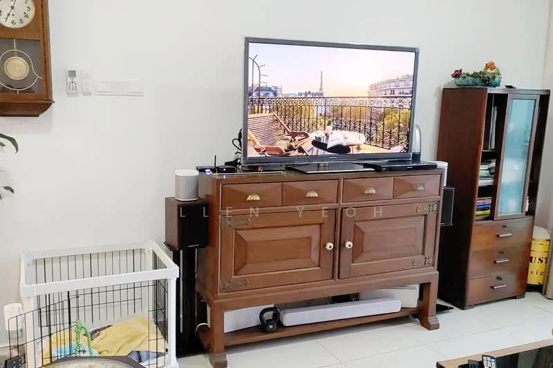Living features: wooden sideboard with drawers, flat-screen TV on stand, white wall, light-colored tiled flooring, black soundbar, wireless speaker, decorative items on sideboard, pet crate, wall clock, shelving unit, window with view, decorative plants; style: modern.