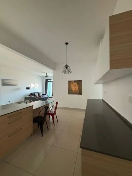 Kitchen features: wood cabinetry, grey countertop, pendant light fixture, tile flooring, open layout, island with seating, stainless-steel appliances, wall-mounted cabinets; style: modern. Living features: sofa, coffee table, wall-mounted TV, decorative artwork; style: modern.