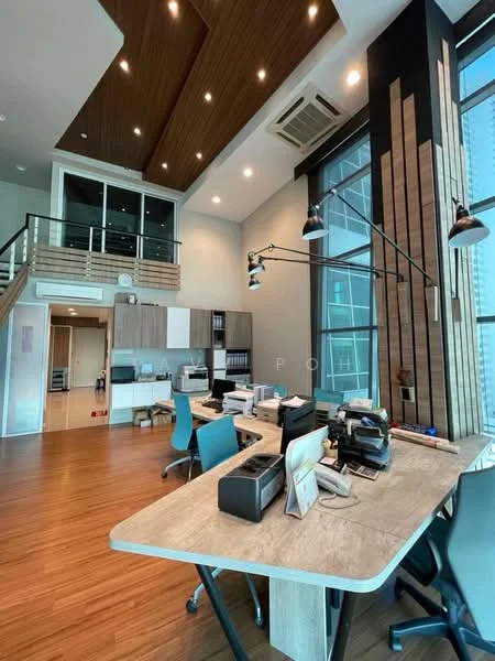 Room features: wooden flooring, high ceiling with wooden panels, large windows with city view, modern office desks, ergonomic office chairs in teal, shelves with office supplies, recessed lighting, air conditioning unit, decorative wall panels, open loft area, multiple workstations; style: modern; view: city.