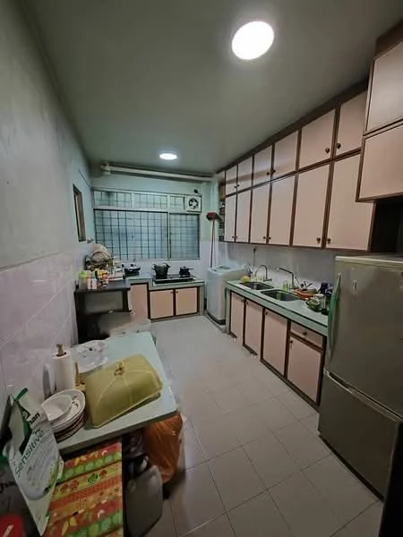 Kitchen features: light green countertops, pink cabinetry, stainless-steel refrigerator, built-in stove with multiple burners, sink with faucet, white tiled backsplash, grey tiled flooring, wall-mounted storage shelves, window with grid pattern, kitchen utensils and appliances visible, dining table with tableware, open shelving with dishes.