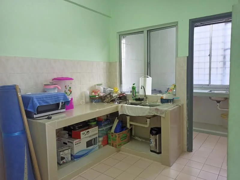 Kitchen features: green painted walls, light-colored tiled backsplash, laminate countertop, single-bowl stainless-steel sink, chrome pull-down faucet, built-in cabinets, open shelving, various kitchen appliances, window with natural light, tile flooring.