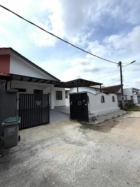 Exterior type: semi-detached house; features: white painted facade, flat roof, black metal gate, paved driveway, covered car porch, manicured lawn, surrounded by residential area, electricity pole with overhead wires; style: modern.