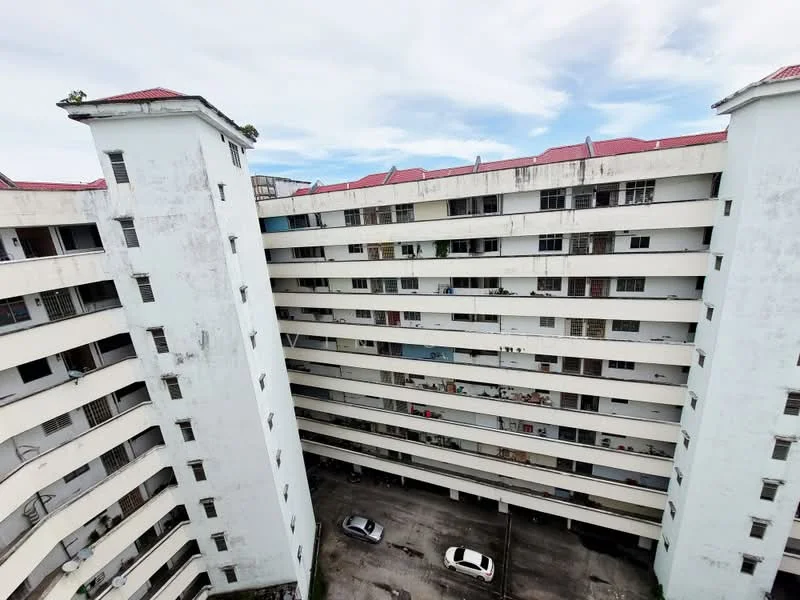 Exterior type: low-rise apartment block; features: white painted facade, red pitched tile roof, 5-storey building, exposed concrete, balconies on each floor, parking area visible, surrounded by open space; style: modern.