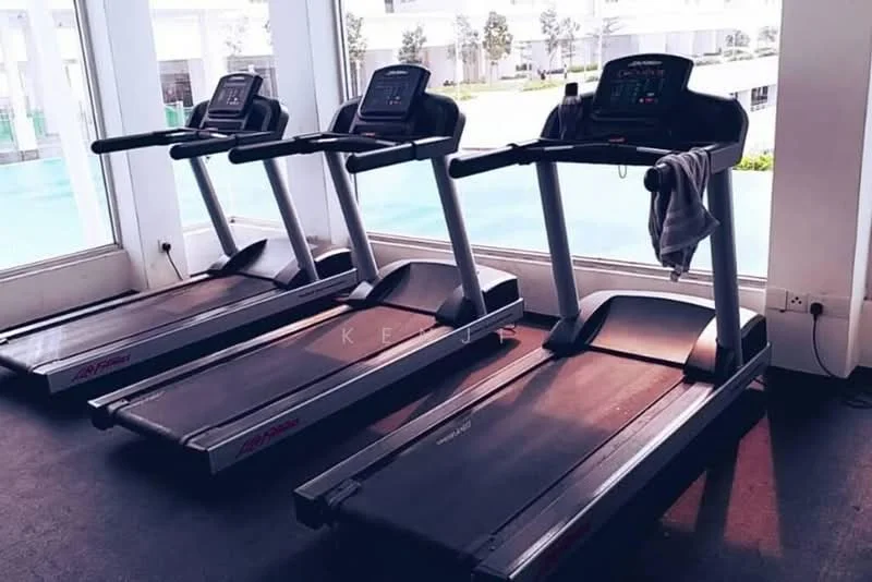 Exterior type: gym; features: three treadmills, large windows, view of outdoor area, rubber flooring, exercise towels on equipment, modern gym equipment; style: modern.