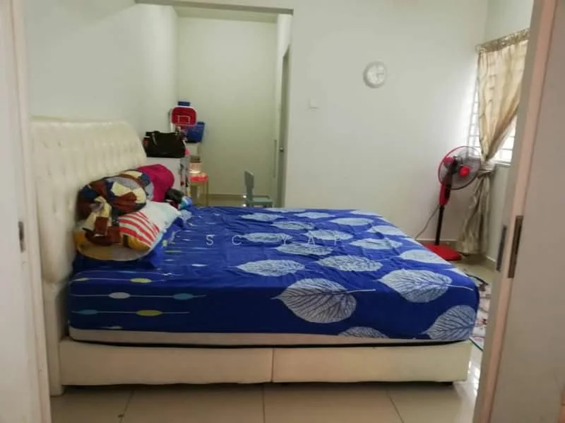 Bedroom features: king-size bed with upholstered headboard, blue bedspread with leaf pattern, white walls, tile flooring, window with sheer curtains, wall clock, standing fan, small table, basketball hoop on wall.