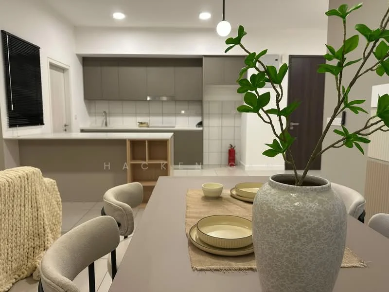 Dining features: round dining table, upholstered dining chairs, decorative vase with plant, neutral table runner, ceramic plates, kitchen cabinetry in grey, white tiled backsplash, stainless-steel appliances visible in kitchen, fire extinguisher on the floor, light fixture above dining table, open-plan layout with kitchen, light-colored flooring; style: modern; view: kitchen.