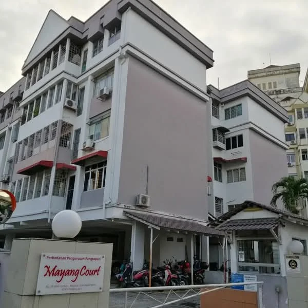 Exterior type: low-rise apartment block; features: white painted facade, grey painted facade, balconies with railings, multiple air conditioning units, covered car porch, parking area with motorcycles, entrance signage, gated entry, landscaped area with palm trees; style: modern.