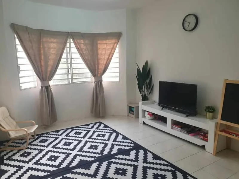 Living features: white painted walls, tile flooring, floor-to-ceiling windows, sheer curtains, blackout curtains, wall-mounted TV, white TV console, decorative plant, clock on wall, area rug with geometric pattern, light-colored armchair, blackboard, books on shelf; style: modern.