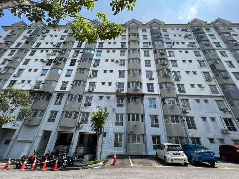 Exterior type: low-rise apartment block; features: white painted facade, multiple balconies, window air conditioning units, ground-level parking area, motorcycle parking, landscaped trees in front, visible parking cones, two-storey building, grey accents on facade; style: modern.