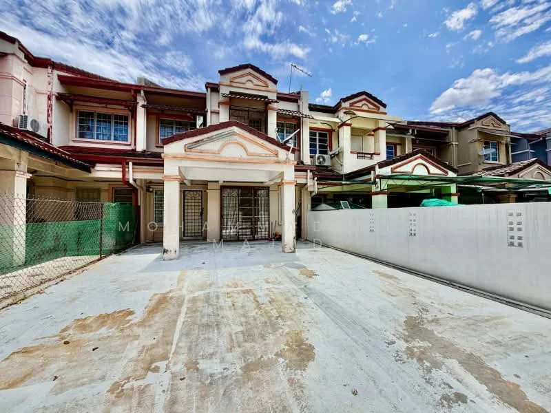 Exterior type: linked terrace house; features: two-storey building, white painted facade, red tiled roof, front porch area, concrete driveway, metal grilles on windows, green awnings over parking spaces, fenced perimeter, mature trees in vicinity, clear blue sky; style: traditional.