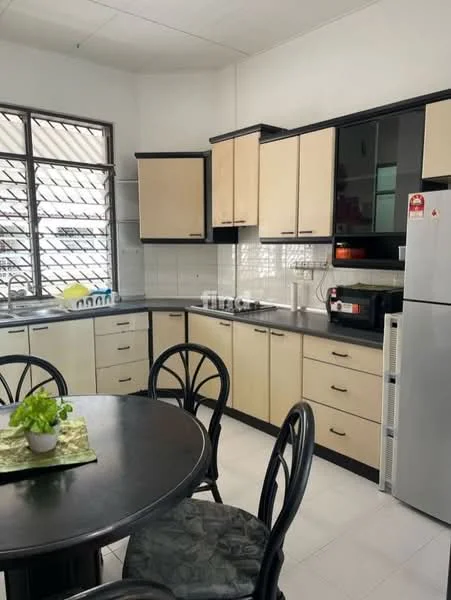 Kitchen features: black and cream cabinetry, stainless-steel refrigerator, built-in oven, ceramic tile backsplash, grey countertop, double-bowl stainless-steel sink, chrome pull-down faucet, round dining table, 4 black dining chairs, window with metal grilles, white tiled flooring, wall-mounted cabinets, kitchen appliances, decorative plant on table; style: modern.