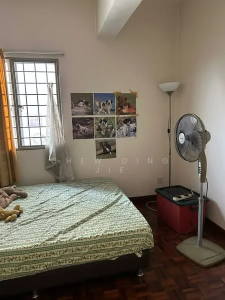 Bedroom features: single bed, green patterned bedspread, wooden flooring, floor lamp, standing fan, curtains, wall-mounted animal posters, window with grid, brown wooden furniture, stuffed toy on bed.