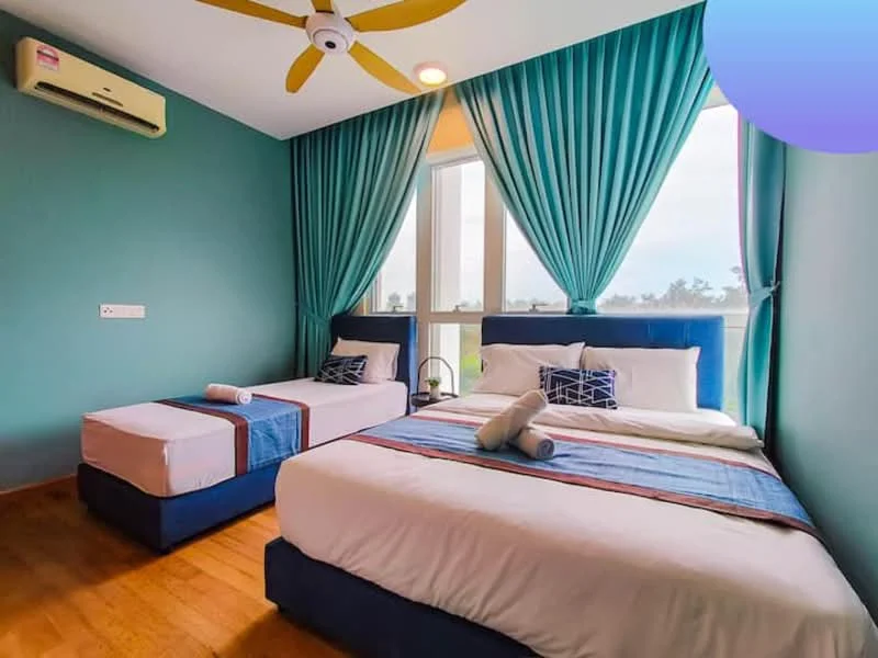 Bedroom features: king-size bed with blue upholstered base, single bed with blue upholstered base, wooden flooring, turquoise painted walls, floor-to-ceiling windows, sheer curtains, 5-blade ceiling fan with light, decorative pillows, bedside table, wall-mounted air conditioning unit; style: modern; view: garden.