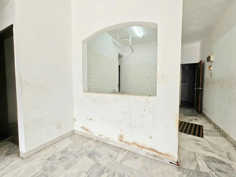 Room features: white painted walls, marble tile flooring, arched opening, exposed plumbing, tile backsplash, light fixture on ceiling, doorway leading to another room, doormat at entrance.