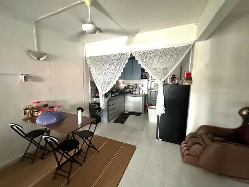 Kitchen features: white walls, tile flooring, ceiling fan, kitchen cabinets in grey, stainless-steel fridge, built-in oven, countertop, kitchen sink, dining table with chairs, decorative lace curtain; style: modern. Living features: brown leather sofa, area rug, wall-mounted decor; style: modern.