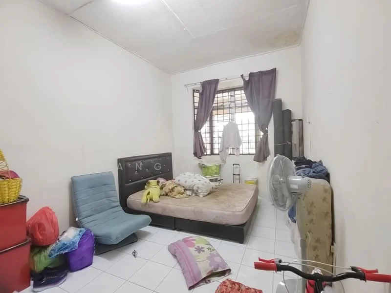 Bedroom features: queen-size bed, upholstered headboard, floor-to-ceiling window with curtains, white painted walls, tiled flooring, ceiling fan, clothes rack, plastic storage bins, bicycle, messy bedding, decorative pillows.