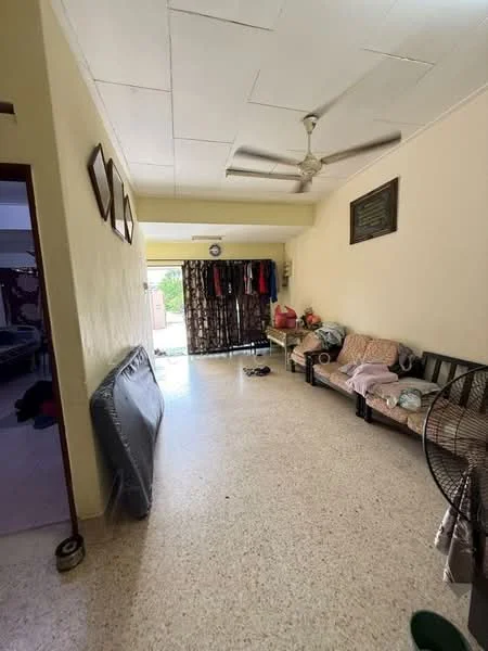 Room features: ceiling fan, light-colored walls, tile flooring, sofa with floral upholstery, wooden coffee table, curtains, open space leading to outdoor area, decorative wall frames, sliding glass door, shoes on the floor, clothes hanging on a rack; style: modern.