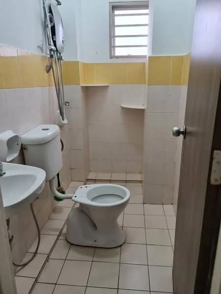 Bathroom features: white toilet, single-sink vanity with wall-mounted faucet, shower with handheld shower head, yellow tiled wall, white tiled wall, ceramic tile flooring, small window, shelf above toilet, water heater, mirror above sink.
