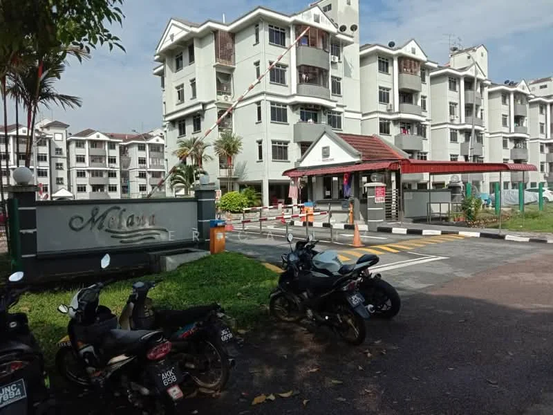 Exterior type: low-rise apartment block; features: white painted facade, red tiled roof, manicured lawn, palm trees, security gate, guard house at entrance, parking area with motorcycles, surrounded by greenery; style: modern.