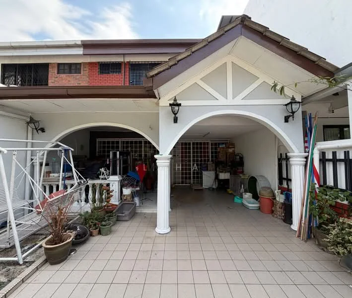 Exterior type: semi-detached house; features: arched entryway, white painted columns, tiled flooring, gabled roof with brown tiles, exposed brick wall, outdoor seating area, landscaped garden with potted plants, security grille, outdoor lighting fixtures; style: traditional.